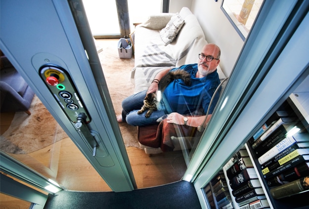 Homelift user travelling in his Stiltz lift with his dog